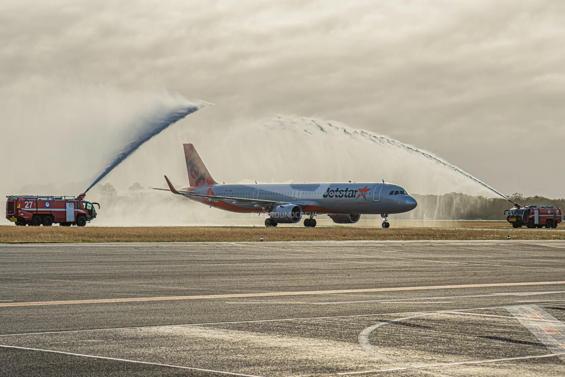 Jetstar aircraft beneath a water salute